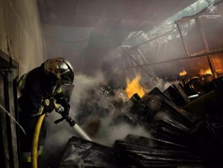 Photo shows firefighter putting out fire after Russian attack