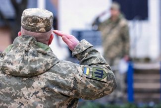 Zdjęcie przedstawia salutującego ukraińskiego żołnierza 