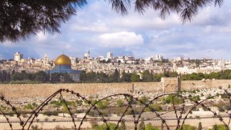 Panorama of Jerusalem behind barbed wire