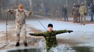 Canadian and American soldiers train in freezing water in Latvia