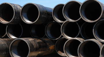 Stack of pipes waiting to be installed at a gas well